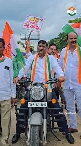 Gouri Satish leading a campaign rally on a decorated motorcycle