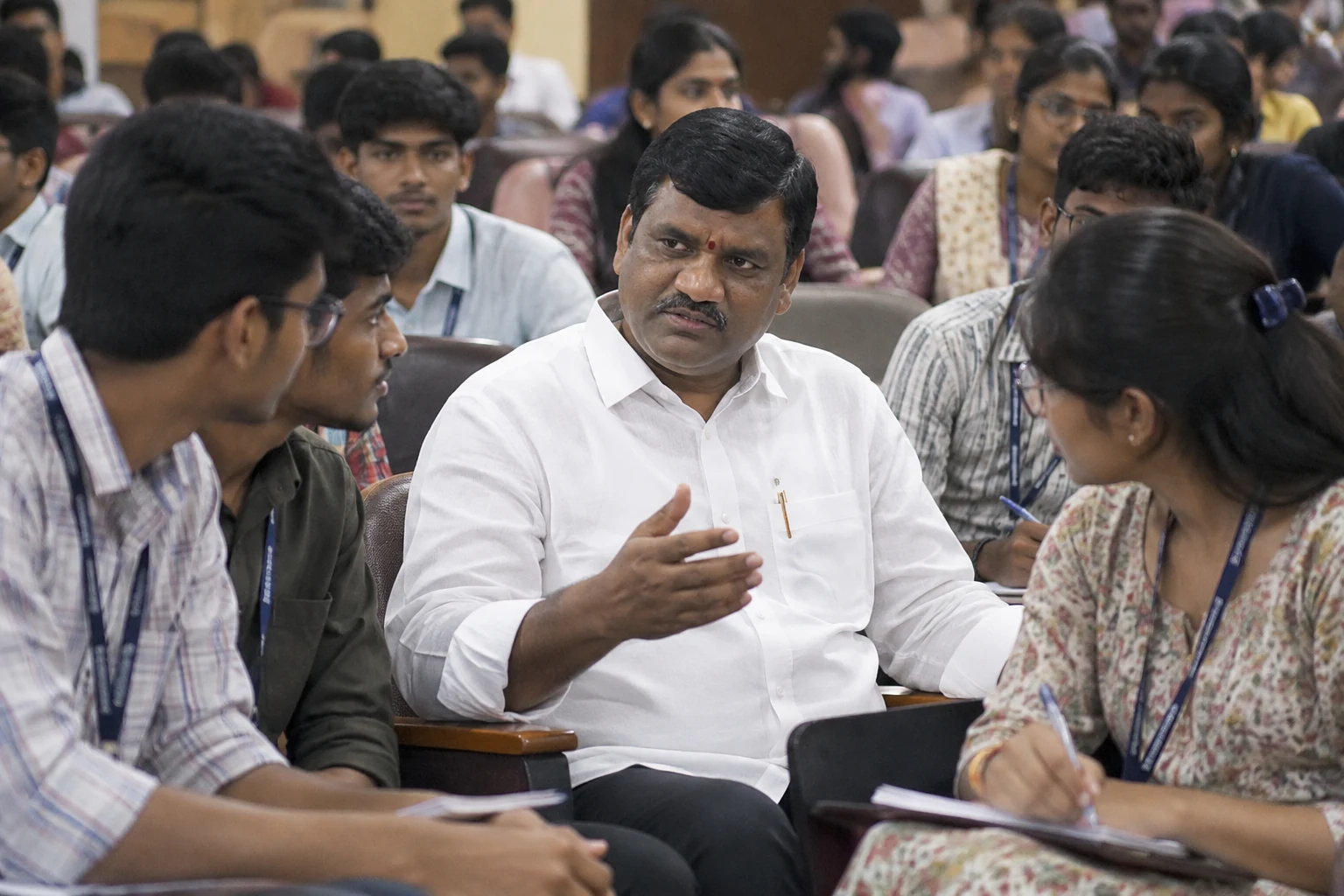 Gouri Satish in discussion with students in a packed lecture hall